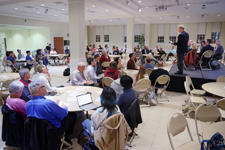 DCI Building Democracy event attendees gather at tables in the Lilly Gallery