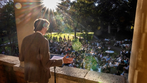 A student speaking from the balcony at the Phi Eu Debate
