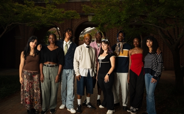a group of students standing together on a college campus