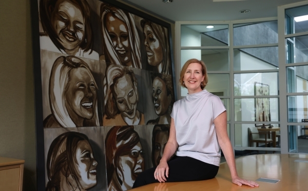 YWCA's Kirsten Sikkelee in front of painting
