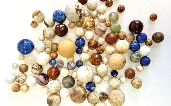 Colorful marbles of all sizes on a white background