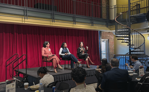 Three female panelists sit onstage in the 900 room on Davidson's campus