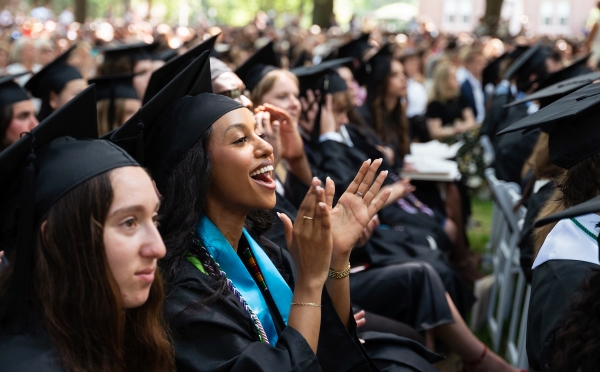 Student smiles and claps at Commencement 2026