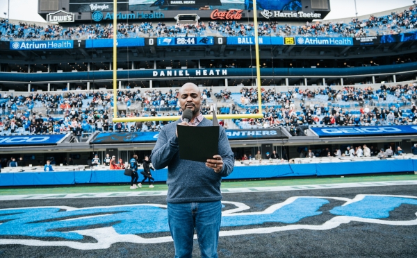 Daniel Heath reading to the crowd as the inaugural chaplain for Charlotte Football Club (Charlotte FC),