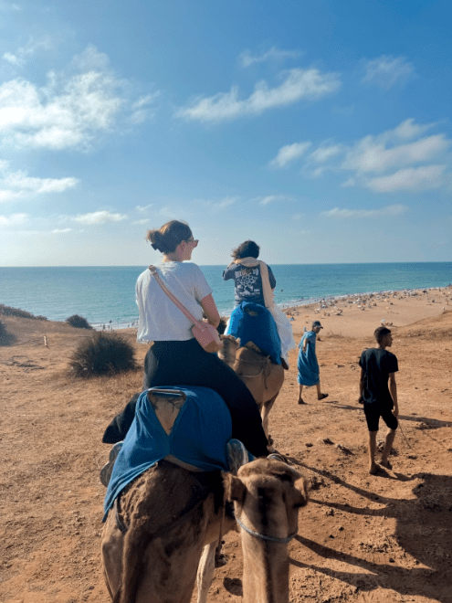 Ann Thompson riding a camel in Spain