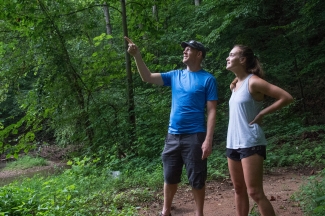 Prof. Brad Johnson and student work in the field as he points out something above them
