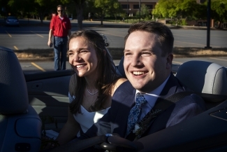 Caroline Bell '17 with husband Tyler Peterson smiling in car 