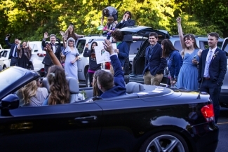Guests waving from cars 