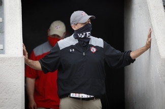 Coach Abel of Davidson Football Walking Out in a Mask that Says "We"