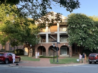 families watch vignette near campus apartments from cars