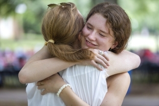 Student Says Goodbye to Family and Hugs Family Member at Farewell Picnic