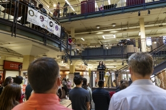 crowd of students and staff listen to President Carol Quillen speak at celebration
