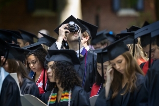 Student taking picture with camera at Class of 2022 Commencement