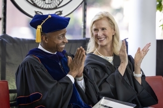Professor Philip Jefferson and Trustee Alison Hall Mauze clapping at Class of 2022 Commencement