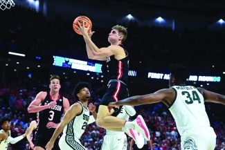 Davidson basketball player jumping to dunk the ball