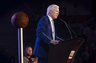 Steph Curry looks on as Coach McKillop speaks during Curry for 3 Event