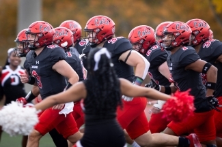 Cheerleader in front of the football team
