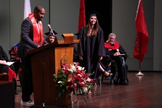 Student being recognized onstage at Convocation