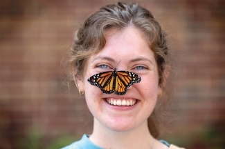 Ellie Rice with monarch butterfly on her nose