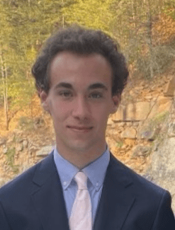 a young white man wearing a suit and tie