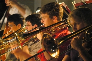 Horns during music performance by Bill Giduz