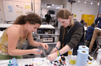 a group of students work together in an art studio