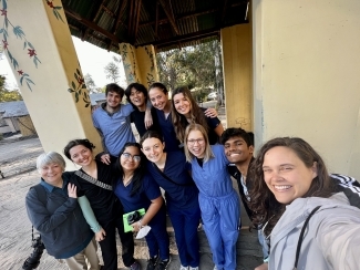 a group of students smiling together taking a selfie