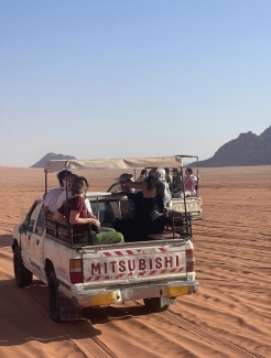 a truck filled with people in a desert