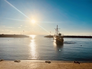 a ship on water on a sunny day