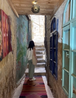 a young woman walks in a hallway