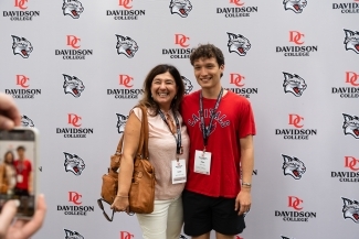 New student and woman pose for a photo at the orientation picnic