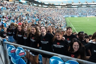 Student linking arms at Charlotte FC game