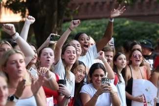young women cheer on runners