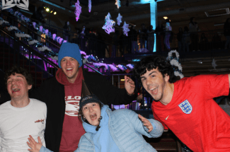 a group of students smiling together in winter gear