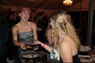 two young women laugh and talk together