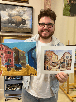 a young man holds up a painting next to the inspiration photo