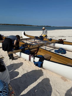 a group of canoes tied together with bamboo sticks