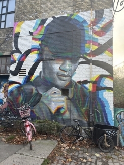 a mural on a brick wall in a city