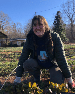 Mena Tanner ’28 harvesting lettuce on the farm