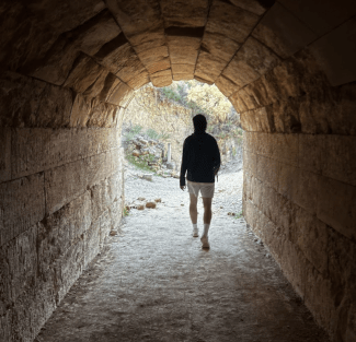  Declan O'Donoghue (‘26) strides through the entrance tunnel of the stadium at Nemea