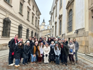 a group of people smiling together in an old city street