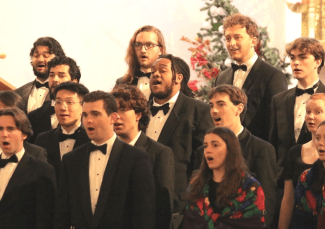 a group of young people sing in an old church during holidays