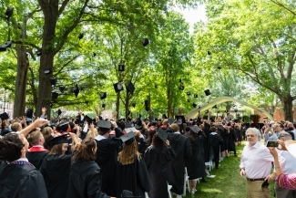 graduation caps in the air on a sunny graduation day