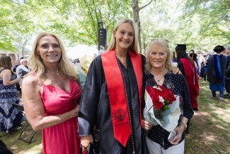 Commencement 2025 grad surrounded by family