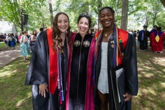 Commencement 2025 three students at ceremony