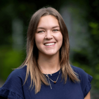a young white woman with blue top and brown hair