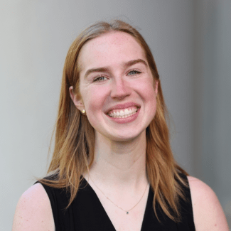 a young white woman with blonde hair wearing a black top