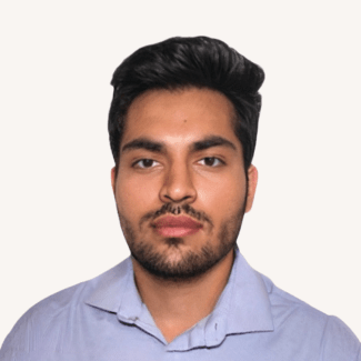 a young man with dark hair and facial hair wearing a collared blue shirt