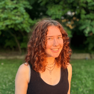 a young white woman with curly brown hair