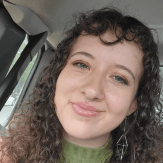a young white woman with curly brown hair